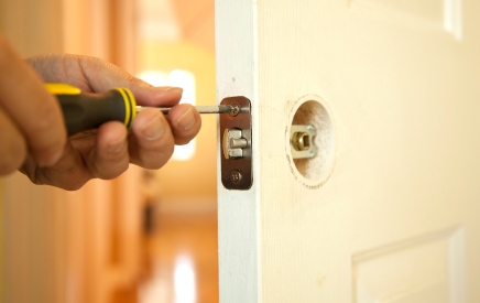 Handyman in Royal Palm Beach, FL fixing door.